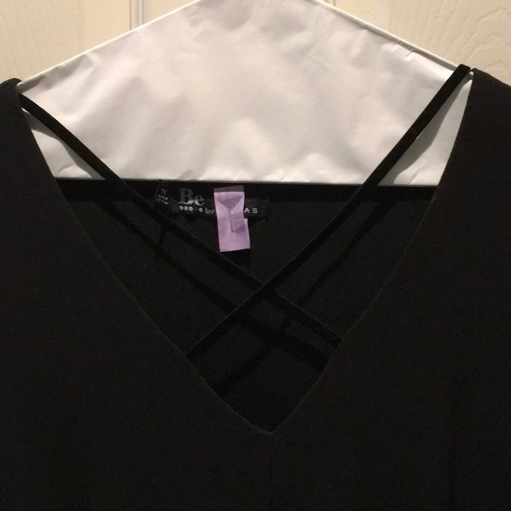 Beautiful black dress with crisscrossed straps at neck and bell sleeves, size 14